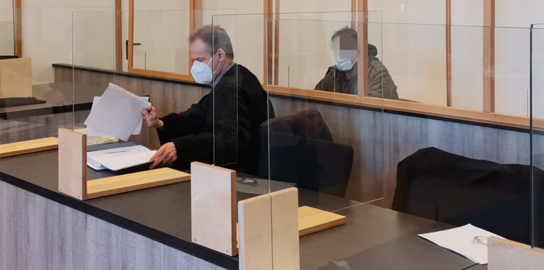 Das Foto zeigt den Angeklagten hinter Verteidiger Thomas Bullmann.