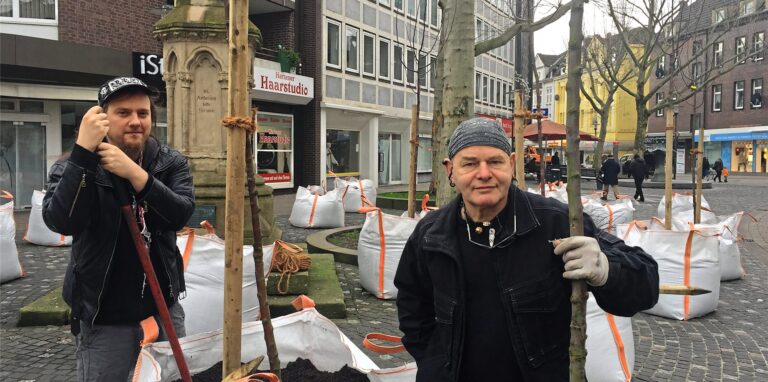 Eine der bereits geförderten Aktionen: Der Künstler Punky Bahr (rechts) und sein Kollege Paul pflanzten rings um das Antoniusdenkmal in der Hertener Innenstadt 24 Bäume in Big-Bags ein.