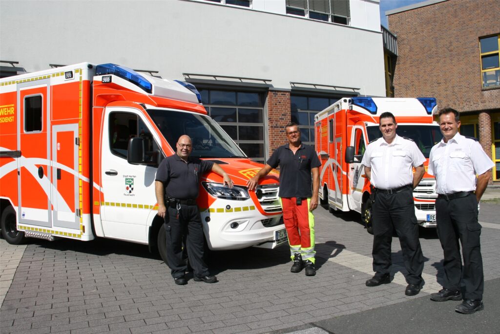 title attribut Die Notfallsanitäter Antonio Morcillo und Carsten Iwanowski sowie die Feuerwehr-Abteilungsleiter Claas-Tido Hoffmann (Rettungsdienst) und Thorsten Geldermann (Technik) stellen die neuen Rettungswagen vor. Die Bögen des Horizontobservatoriums zieren die Seiten.