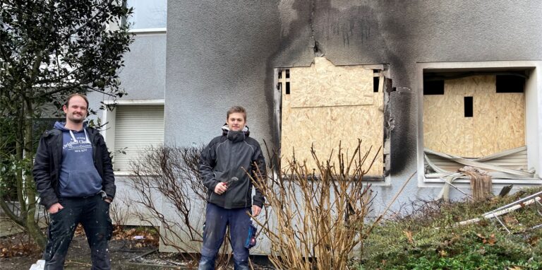 Die Handwerker Marc Lachmann (l.) und Max Ahaus demontieren die kaputte Heizung in der ausgebrannten Erdgeschosswohnung.