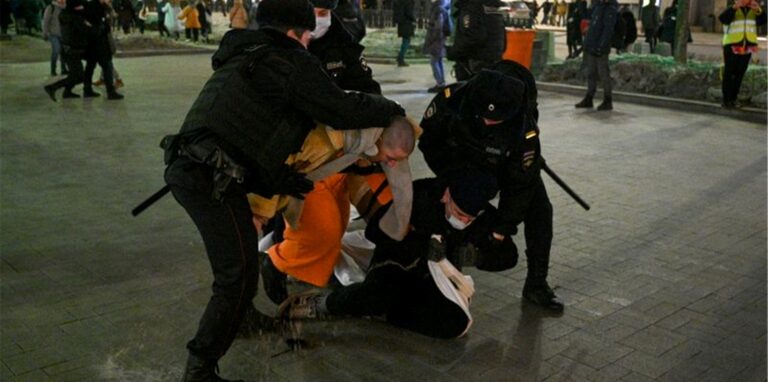 Polizisten halten Demonstranten während eines Protests gegen Russlands Angriff auf die Ukraine fest.