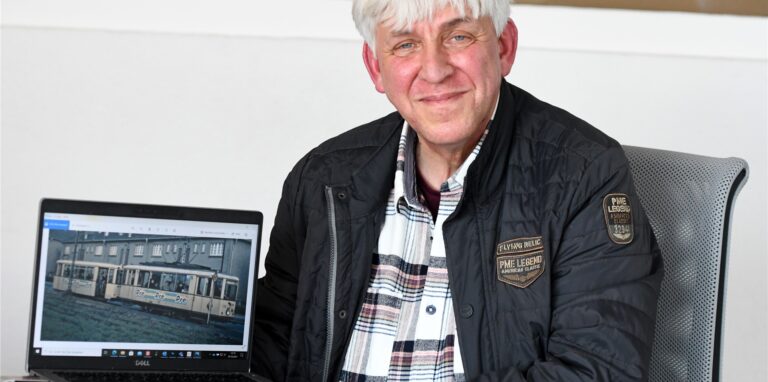Franz-Josef Hauke zeigt auf einem Computer Fotos des Triebwagens 342 aus Recklinghausen, über den er ein Buch geschrieben hat.