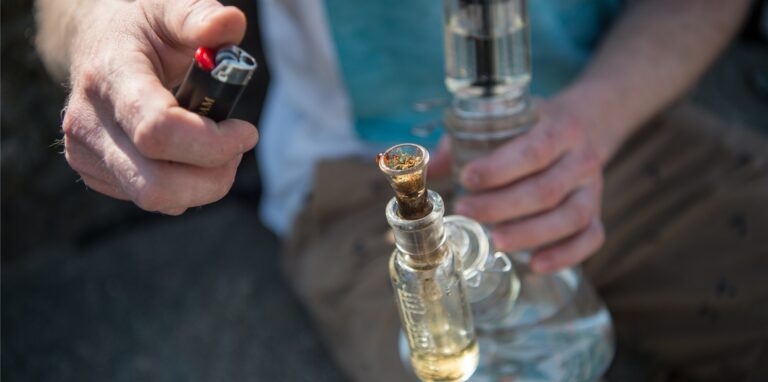 Ein Mann hält eine Wasserpfeife in der Hand.