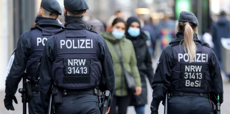 Polizisten laufen auf der Kölner Schildergasse Streife.