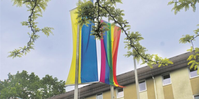 Vor dem Oer-Erkenschwicker Rathaus sind am 17.5. eine Regenbogen- und eine Ukraine-Flagge gehisst.