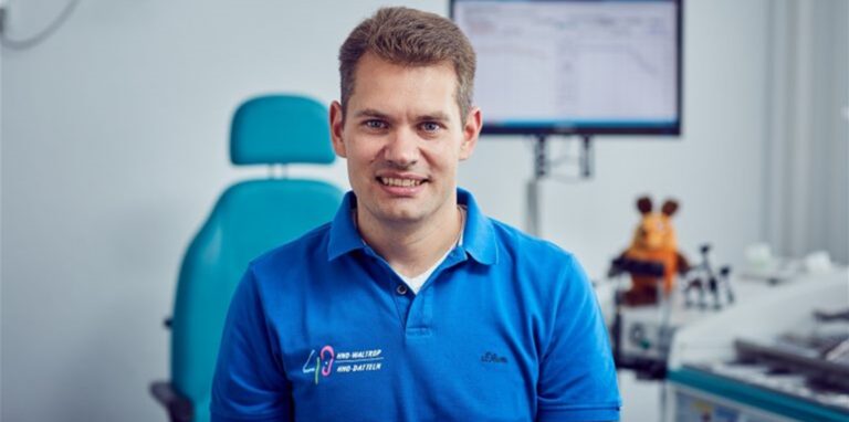 Der Waltroper Arzt Dr. Felix Gahlen steht im blauen Poloshirt in der Arztpraxis.