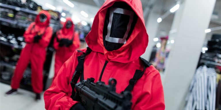 Mitarbeiter des Kostümhändlers Deiters posieren in Kostümen aus der Serie „Squid Game“ des Streaming-Anbieters Netflix.