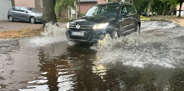 Auto fährt durch große Pfütze