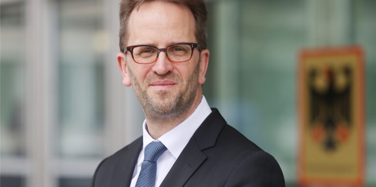 Klaus Müller, Präsident der Bundesnetzagentur, steht vor dem Haus der Bundesnetzagentur.