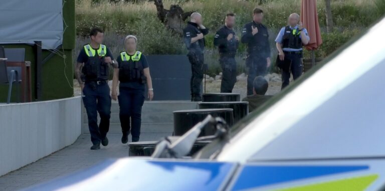 Polizeibeamte stehen vor einem Gebäude
