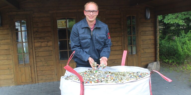 Frederic Baumhöfner von der Jugendfeuerwehr Waltrop mit einem Bigpack voller Kronkorken.