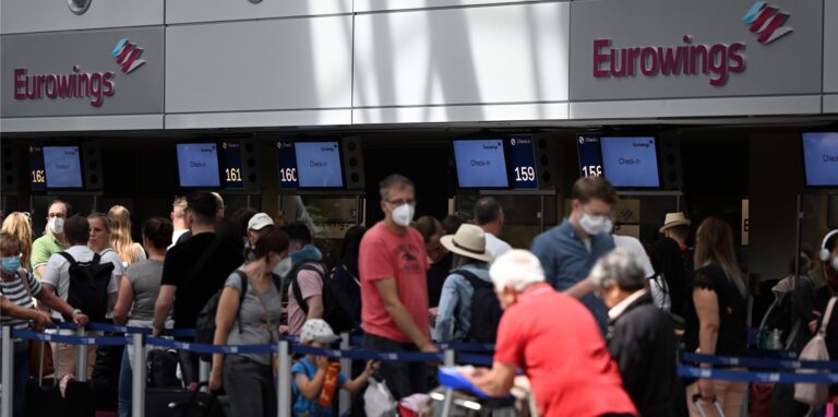 Zahlreiche Passagiere stehen an den Eurowings-Schaltern im Flughafen Düsseldorf.