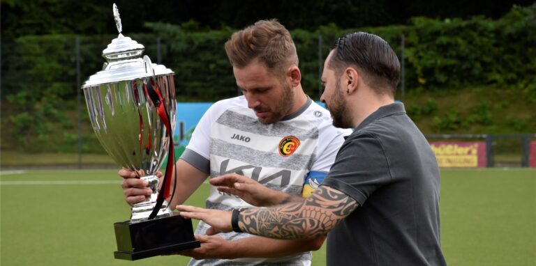 Nach dem Sieg beim Stimberg-Cup 2022 bekommt Erkenschwicks Kapitän Stefan Oerterer silbernen Henkelpott überreicht.