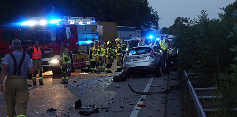 Rettungskräfte stehen am Unfallauto des Geisterfahrers auf der A44 in Höhe des Parkplatzes Grüntal bei Unna auf der Richtungsfahrbahn Dortmund.