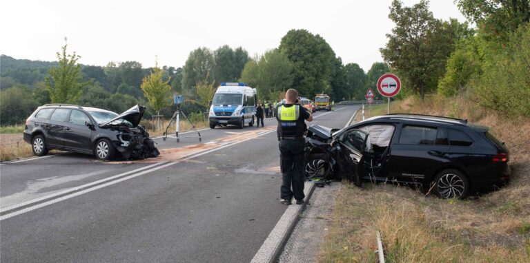 Ein Polizist nimmt an der Unfallstelle die Schäden auf.