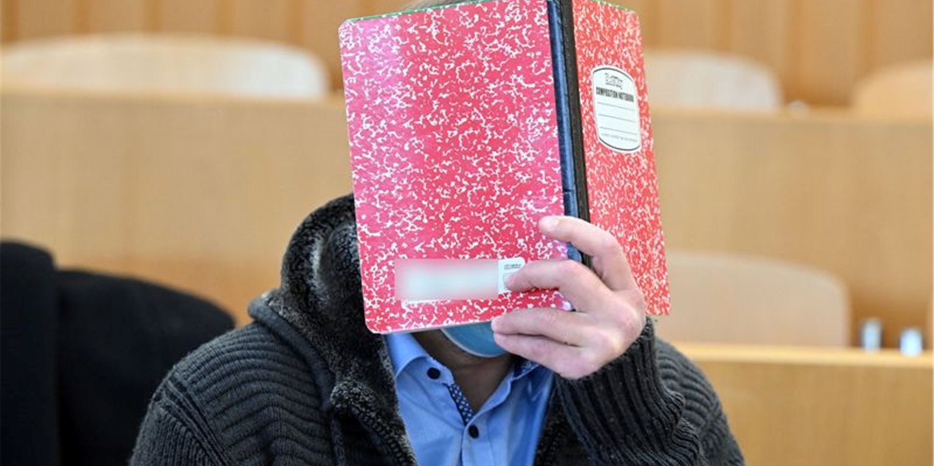 Der Angeklagte im Prozess um eine mutmaßliche Kindesentführung wartet im Amtsgericht auf den Beginn der Verhandlung.
