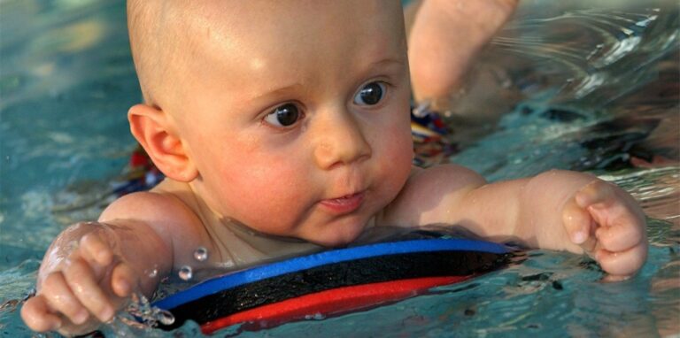 Ein Baby schwimmt im Wsaser.