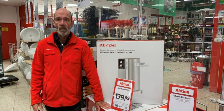 Hagebaumarkt-Leiter Torsten Pauls vor einer Aktionsfläche mit Elektro-Heizgeräten.