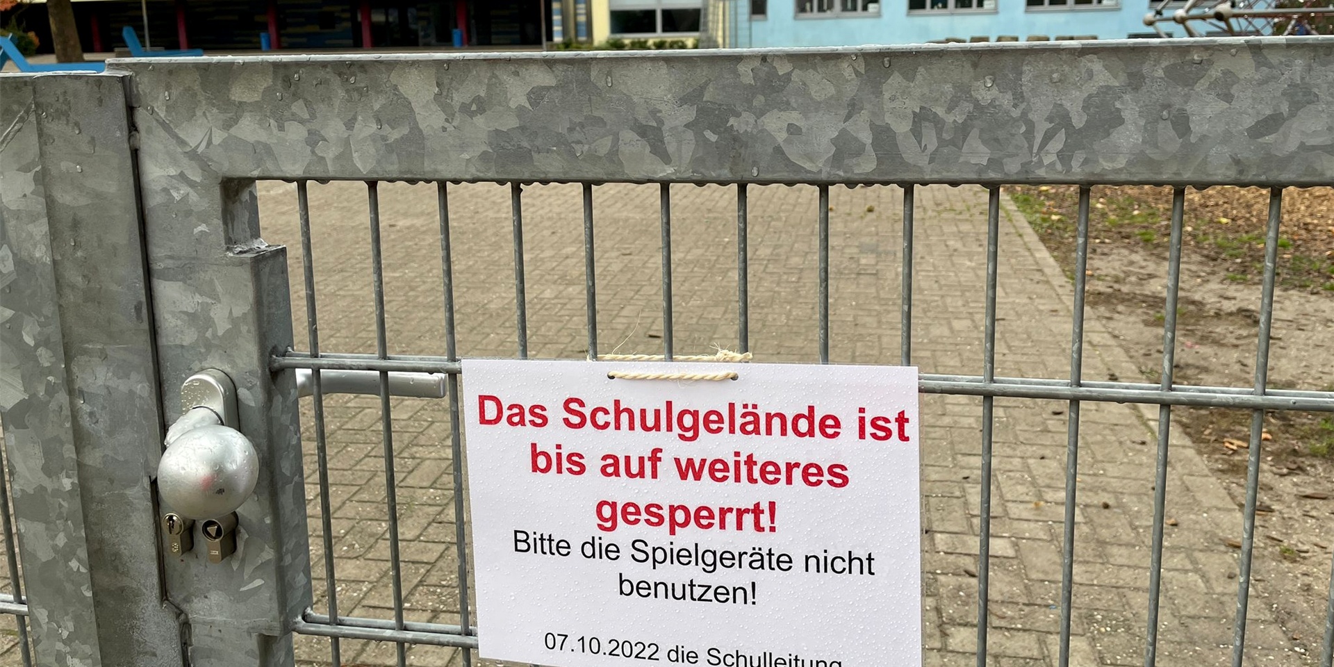 Am Tor zum Schulhof der Grundschule Herten-Mitte weist ein Schild auf die Sperrung hin.