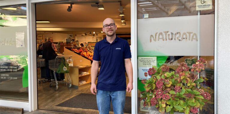 Ein Mann steht vor dem offen stehenden Eingang eines Bioladens in Recklinghausen.