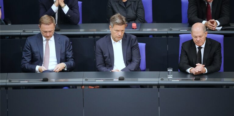 Finanzminister Christian Lindner (FDP, v.l.), Wirtschaftsminister Robert Habeck (Bündnis 90/Die Grünen) und Bundeskanzler Olaf Scholz (SPD) sitzen gemeinsam im Bundestag.