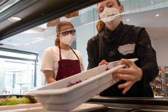 Zum Team des Café Claudius gehören auch die 17-jährige Urtina aus Datteln (l.) und die 20-jährige Selina aus Oer-Erkenschwick. Hier sind die jungen Frauen gerade dabei, die Salatbar aufzufüllen.