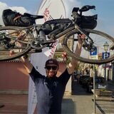 Kilian Wagner, Mitarbeiter von Hase Bikes in Waltrop, hält sein Fahrrad im Ziel des „Two Volcano Sprints“ in die Höhe.