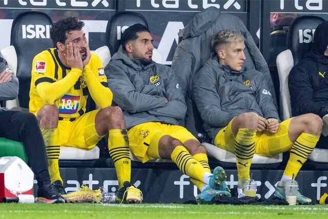Mats Hummels, Emre Can und Nico Schlotterbeck sitzen enttäuscht auf der Bank.