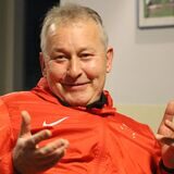 BR Billmerichs Trainer Hubert Tadday sitzt auf einem Stuhl, lächelt und gestikuliert.