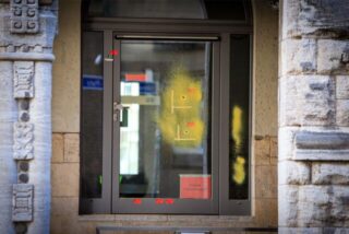 Einschusslöcher sind auf einer verglasten Tür zu sehen. Sie wurden am Rabbinerhaus bei der Alten Synagoge in Essen entdeckt.