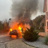 Einsatzkräfte der Feuerwehr Waltrop löschen ein brennendes Auto.