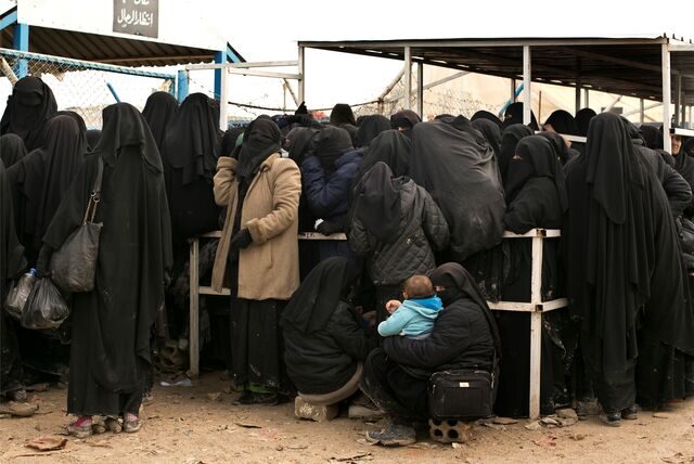 Frauen stellen sich für Hilfsgüter in einem syrischen Lager an.