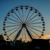 Ein Riesenrad im Sonnenuntergang auf dem Parkfestgelände.