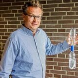 Dirk Schulz, Lehrer am Gymnasium Waltrop, hält ein Modell in der Hand, anhand dessen er die Entstehung eines Tornados erklärt.