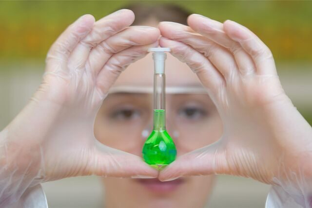 Symbolbild, eine Schülerin hält ein Reagenzglas mit grüner Flüssigkeit vor ihr Gesicht. Der Chemie- und Physikunterricht an Oer-Erkenschwicker Schulen wurde Anfang 2013 auf ein deutlich moderneres Level gehoben.