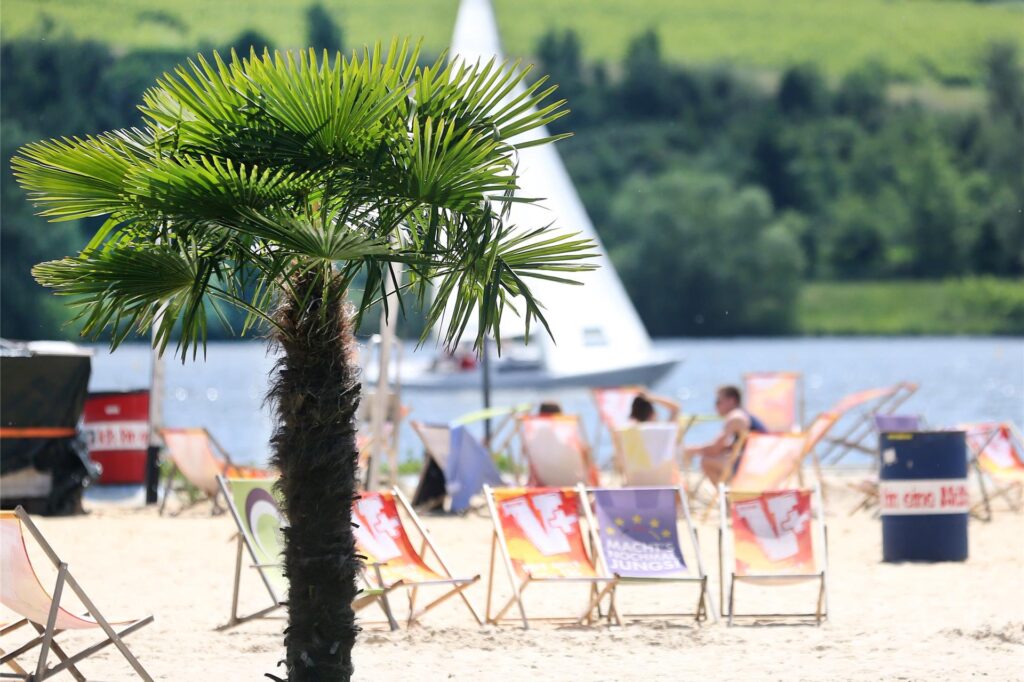 Bei herrlichem Sonnenschein beobachten Besucher des Baldeneysee-Freibades Seaside Beach die Segelboote auf dem Wasser. Bei herrlichem Sonnenschein beobachten Besucher des Baldeneysee-Freibades Seaside Beach die Segelboote auf dem Wasser.