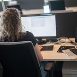 Eine Frau arbeitet an einem Computer.