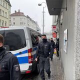 Polizeibeamte verlassen nach den Durchsuchungen am Donnerstag, 9.3. ein Haus in der Saarlandstraße.