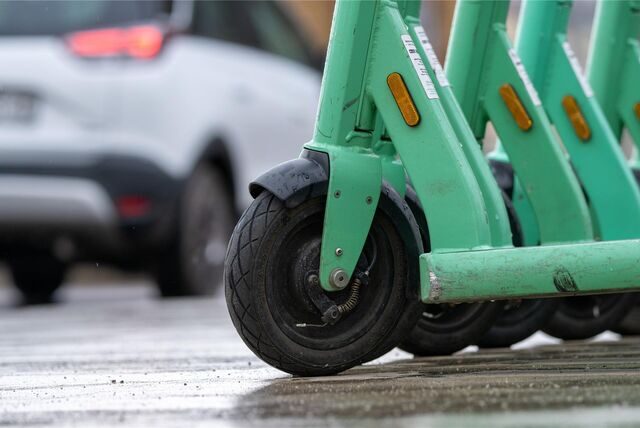 E-Roller zum Mieten stehen auf einer Straße.
