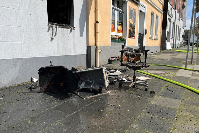 Nach dem Brand im Kaffee Pause an der B235/ Ringstraße liegen Reste von Mobiliar auf der Straße.