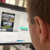 Ein Mann sieht sich auf dem Computer eine Immobilienanzeige an.