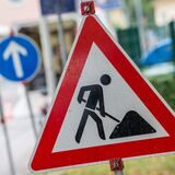Ein Baustellenschild steht am Fahrbahnrand. (Symbolbild)