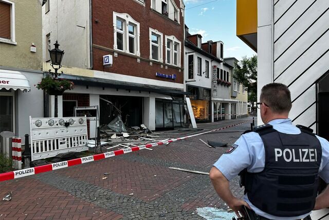 Ein Polizist steht vor einem zerstörten Bankgebäude