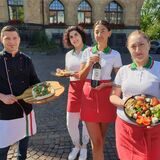 Das Team vom Ristaurante Stella steht auf dem Rathausplatz in Recklinghausen und hält Pizza, Pasta, Antipasti und Rotwein in die Kamera.