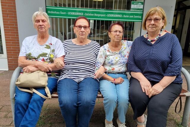 Vier Frauen sitzen auf einer Bank.