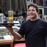 Ein Kellner und eine Kellnerin mit Tablets