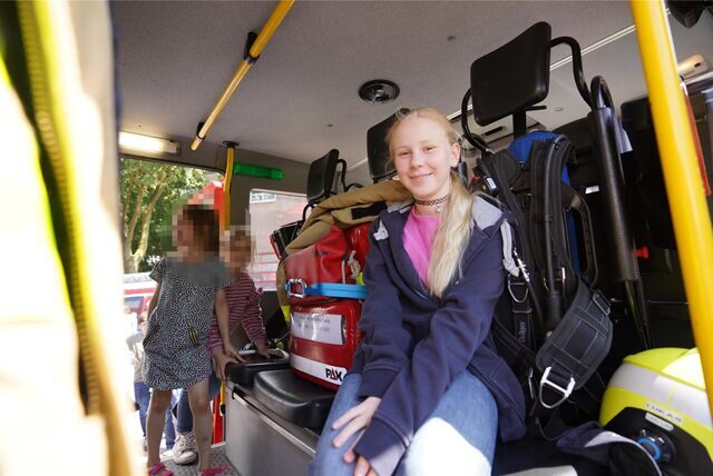 Carlotta Bamberg sitzt beim Tag der offenen Tür der Oer-Erkenschwicker Feuerwehr in einem echten Feuerwehrauto.