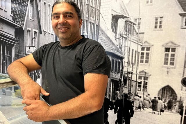 Jeladin Saljuki vor einem historischen Foto