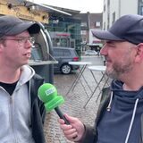 Blick auf eine Reihe von Verkaufsbuden mit vielen Menschen davor.