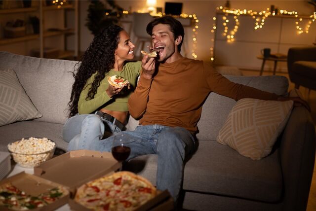 paar isst pizza auf der couch